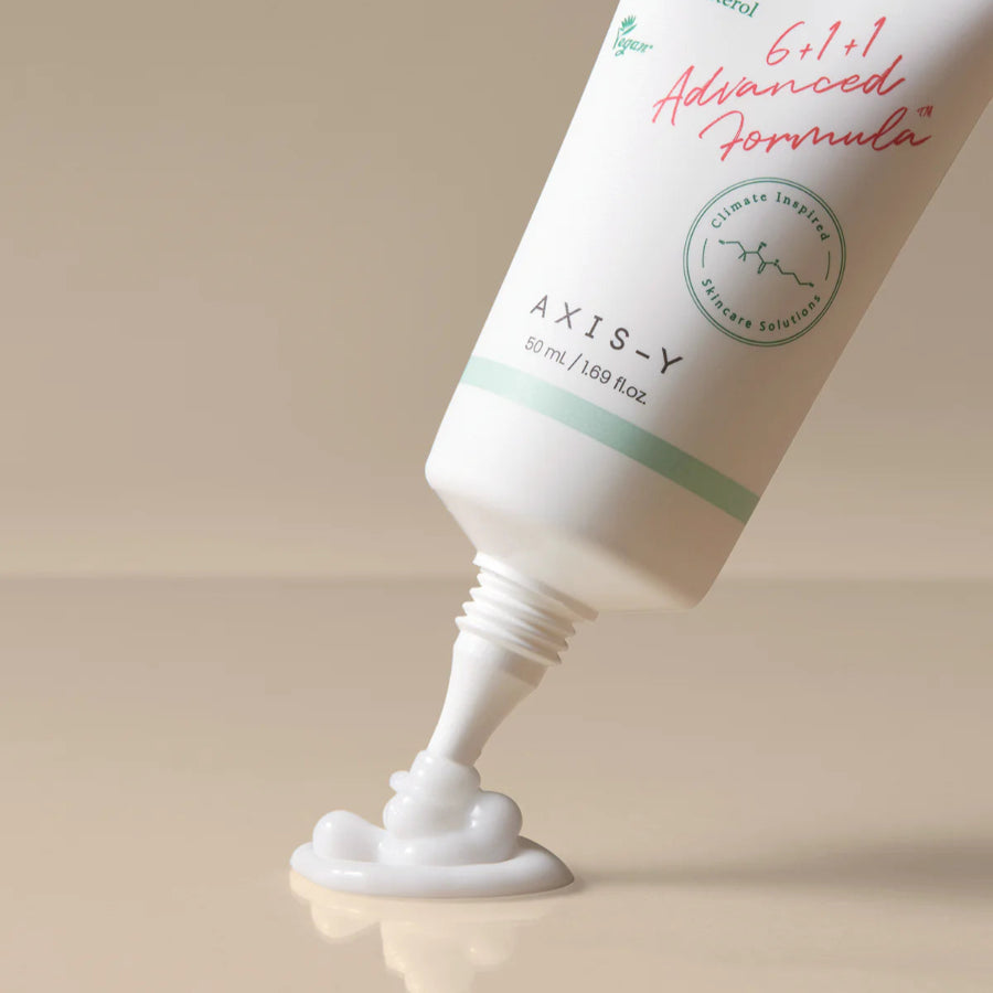 Image showing the Axis-Y Panthenol 10 Skin Smoothing Shield Cream being dispensed from the tube. The tube has a long and thin spout for precise application.
