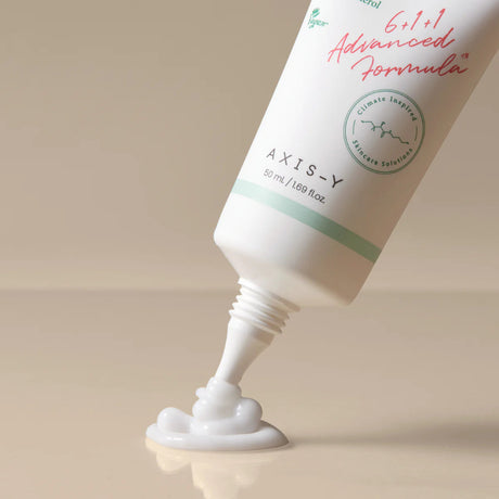 Image showing the Axis-Y Panthenol 10 Skin Smoothing Shield Cream being dispensed from the tube. The tube has a long and thin spout for precise application.