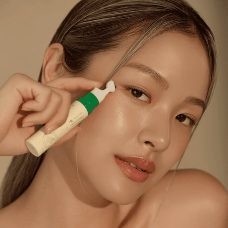 Model posing with the Axis-Y Vegan Collagen Eye Serum.